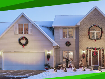 Snow covered house with Christmas lights and decorations