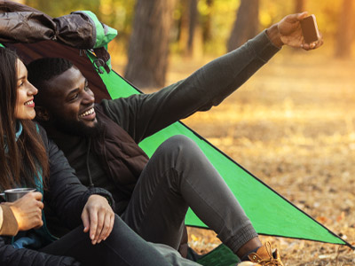 Two Young Adults Taking a Selfie in a Tent