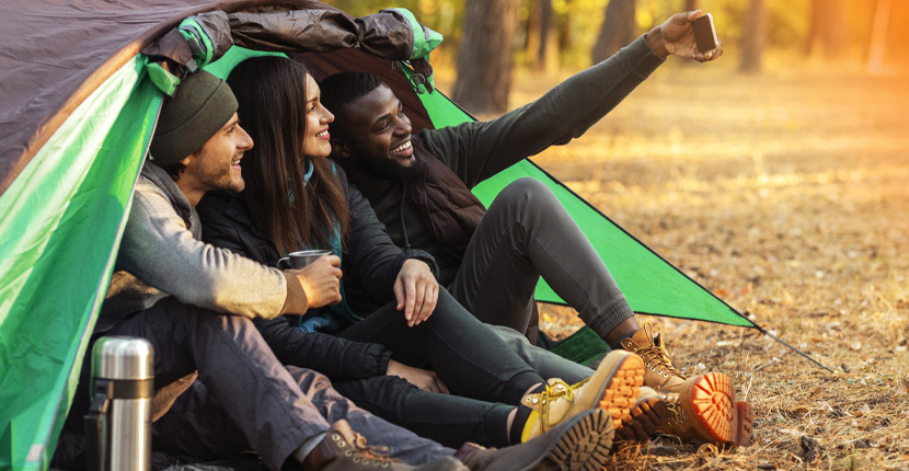 3 people taking a selfie in a tent entrance