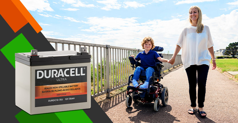 Mom walking with son who is in an automatic wheelchair