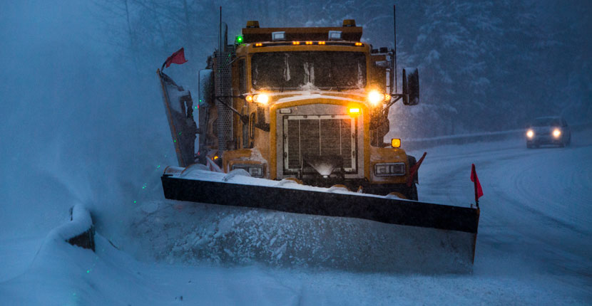 Snow plow truck plowing snow from the street